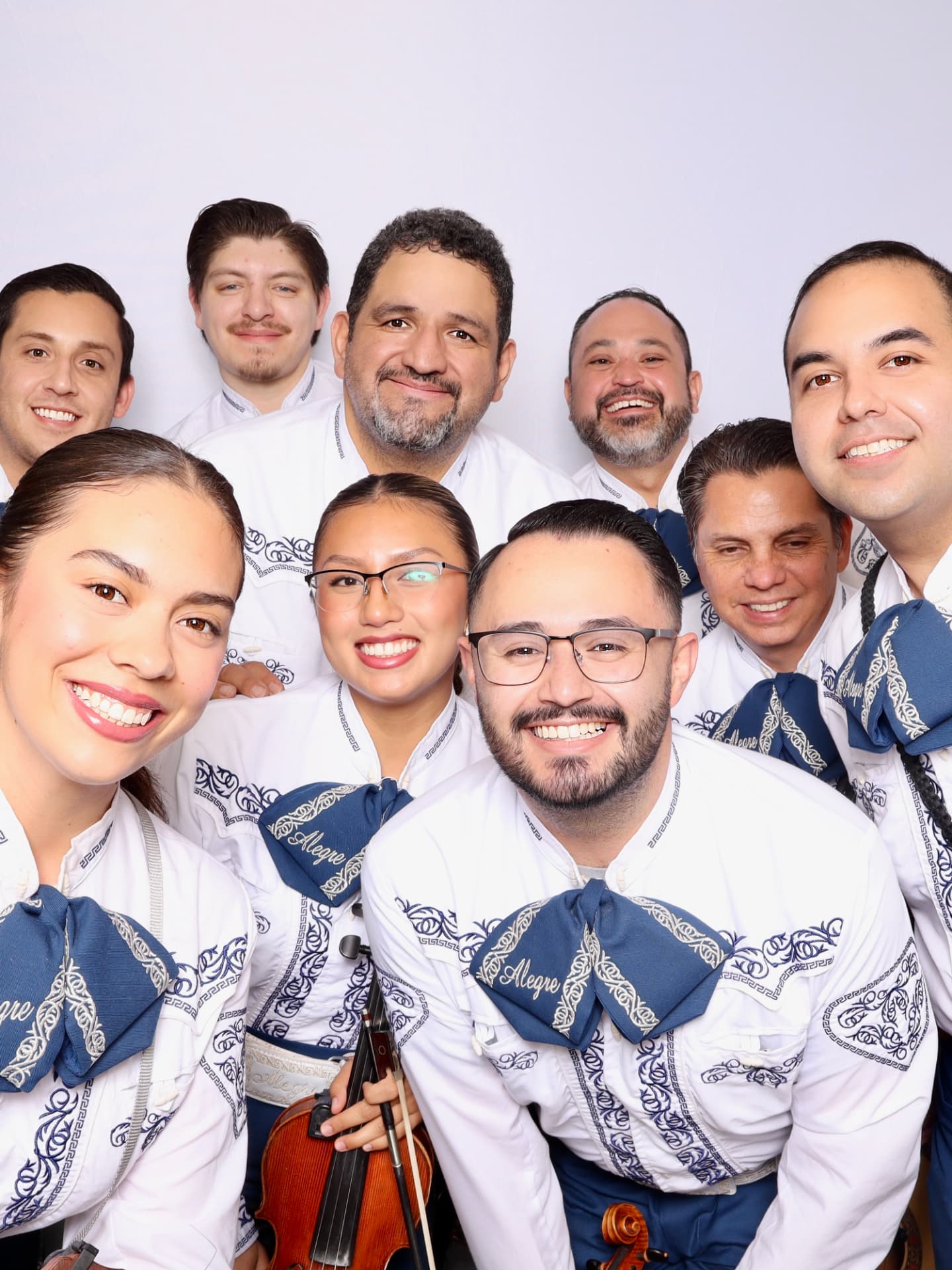 Mariachi Alegre ensemble smiling for a group photo
